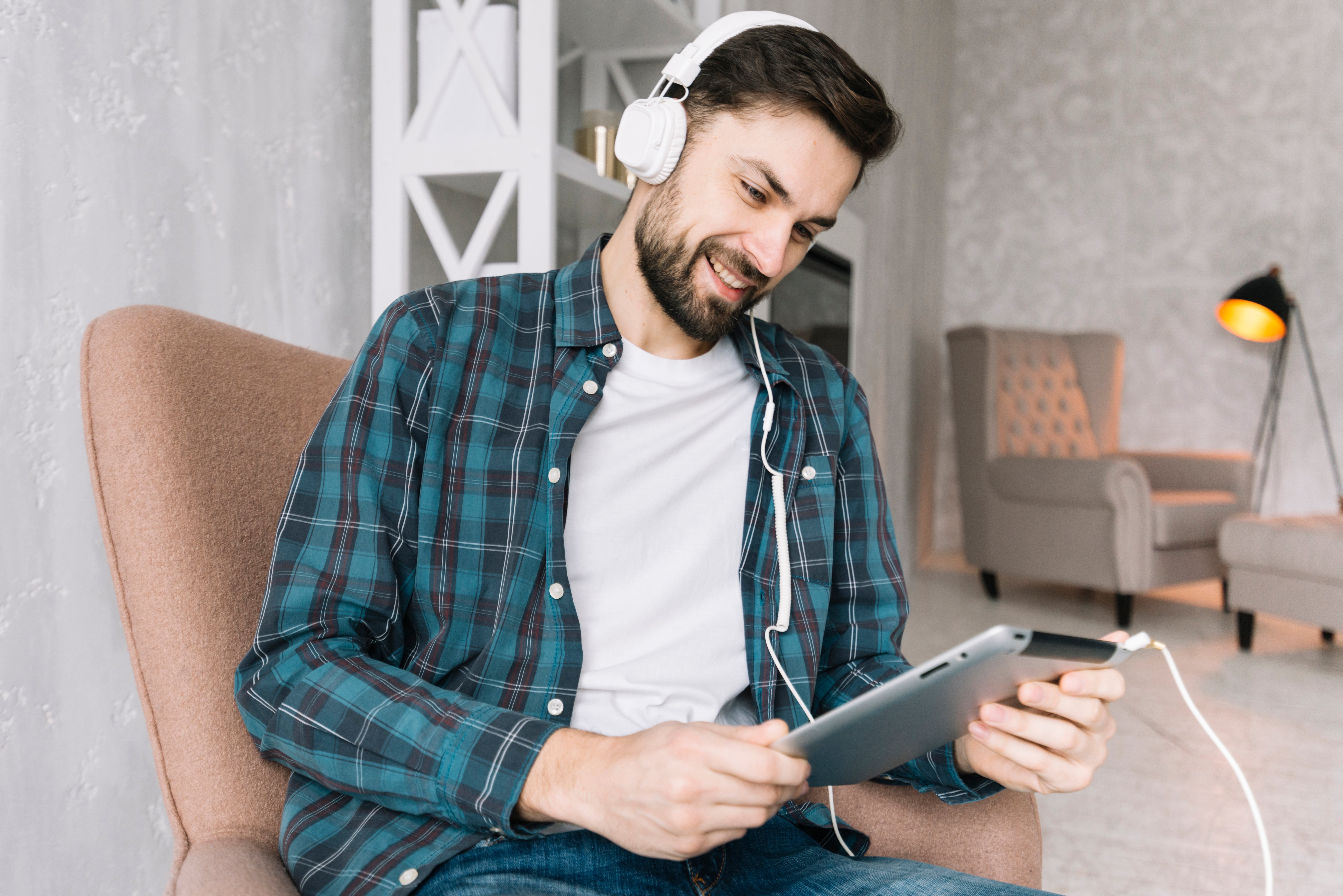 man-using-tablet-listening-music