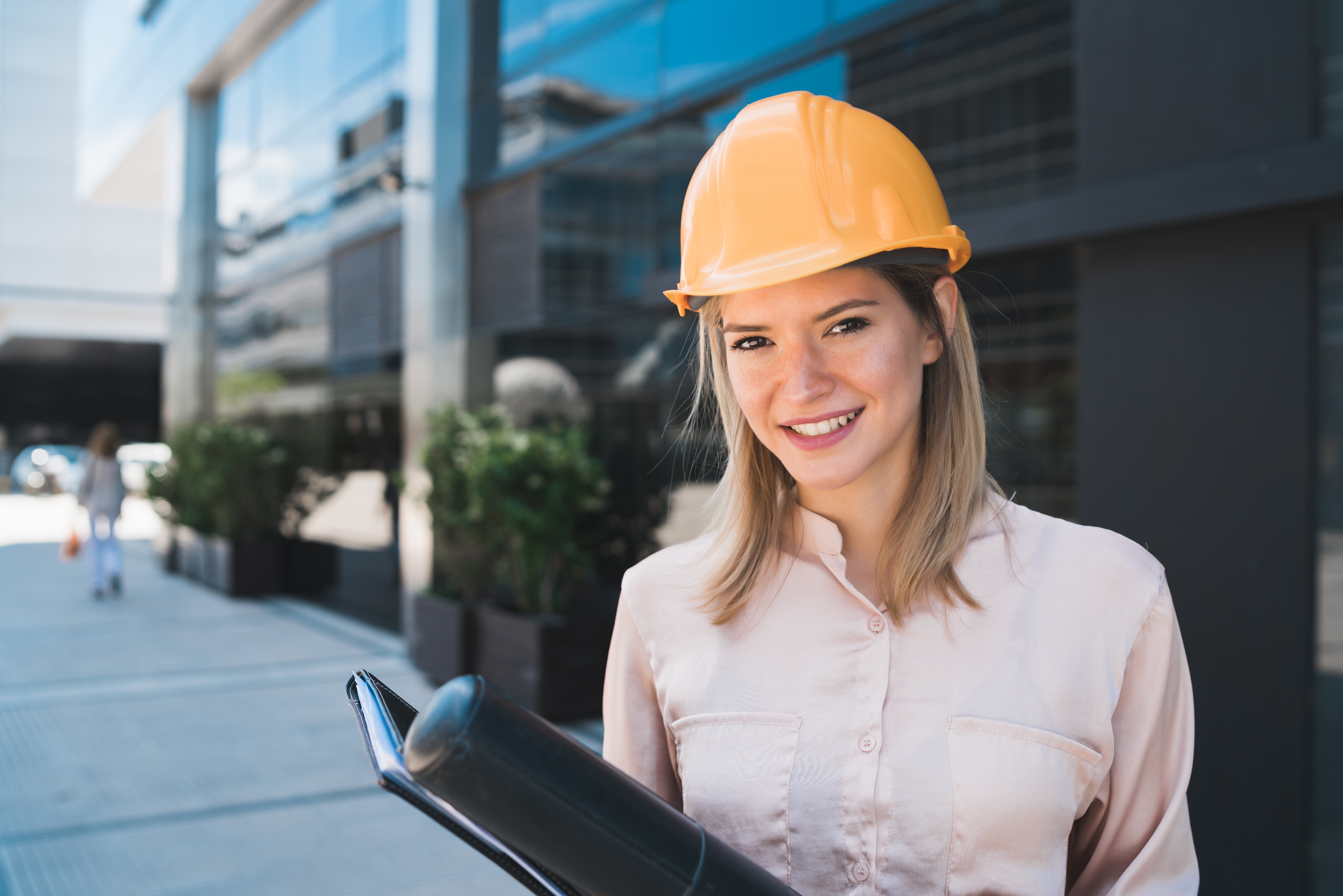 portrait-of-professional-architect-woman-wearing-yellow-helmet-and-standing-outdoors-engineer-and-architect-concept