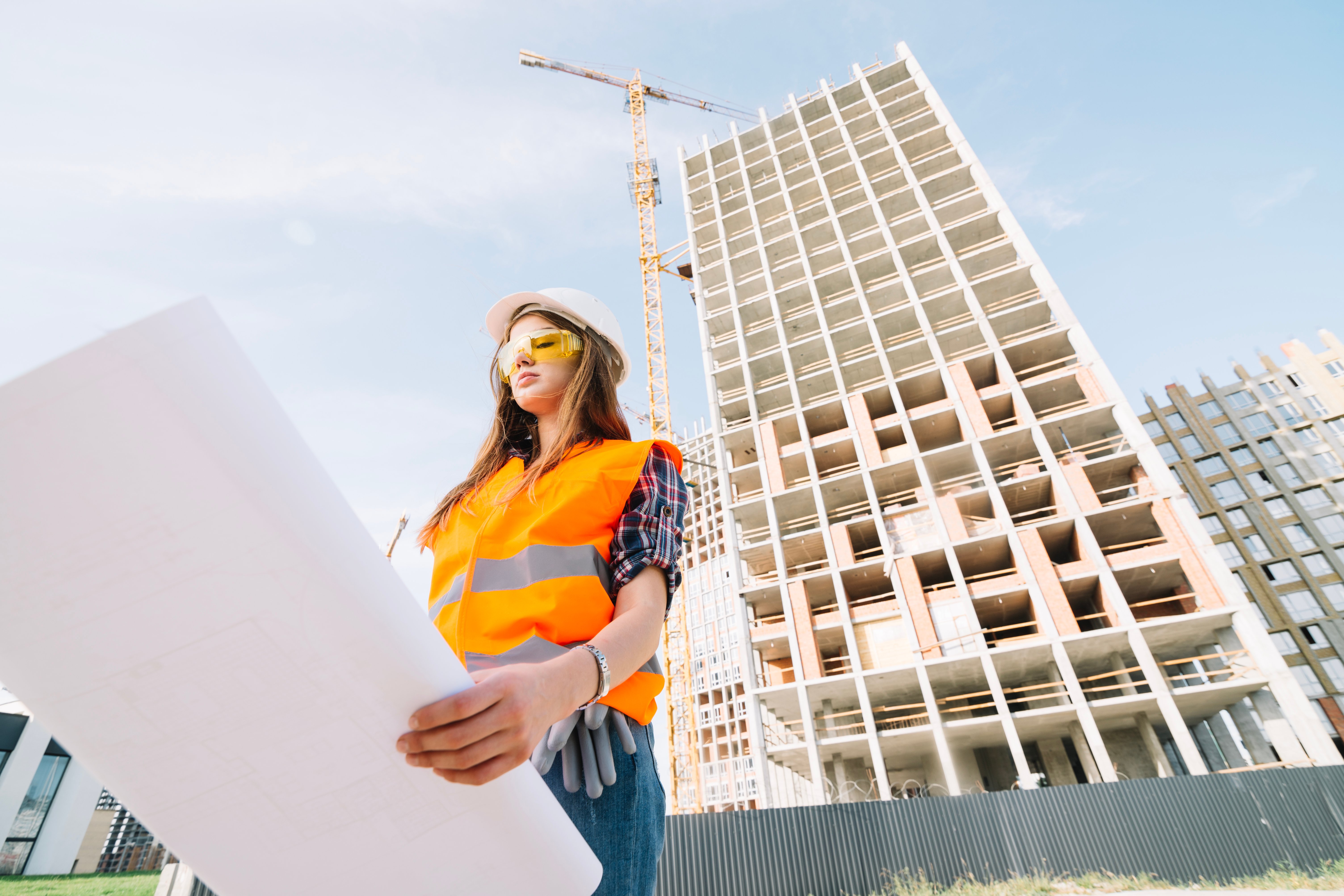 woman-studying-draft-on-construction-site
